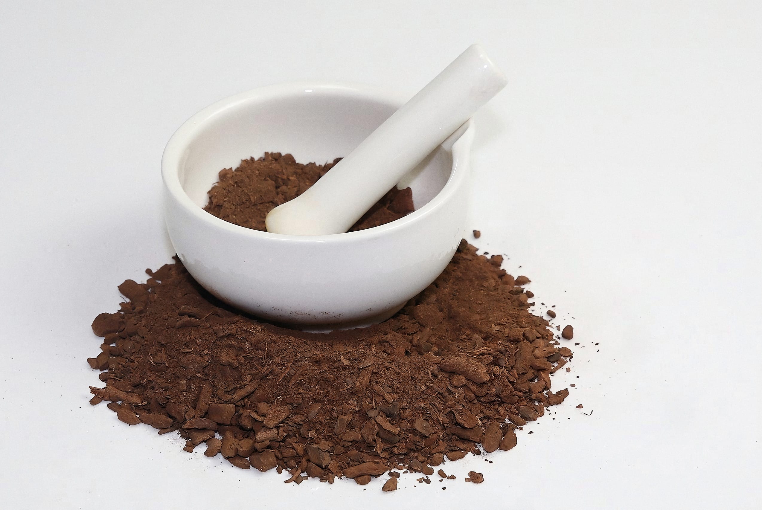 Ground pelargonium root powder in a white mortar and pestle